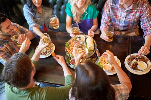 Friends gathered around a table with food and drinks