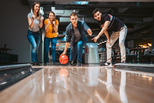 Four teens bowling