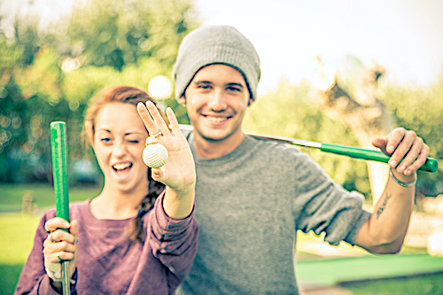 Couple playing mini golf