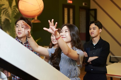 Group playing basketball arcade game