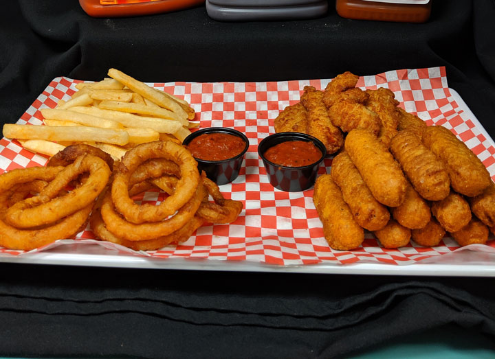 sampler platter with fried mozzerella sticks, onion rings, mac n cheese bites, and french fries